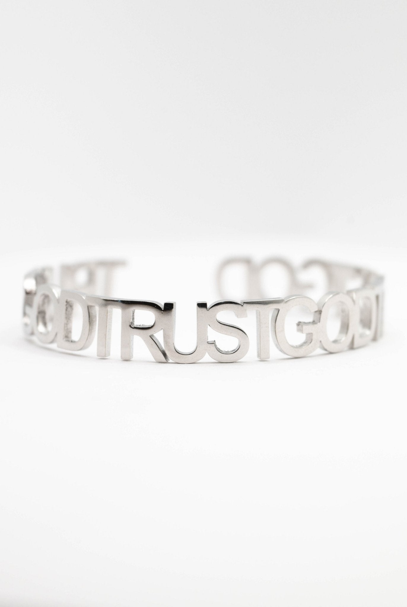 Close-up of the Trust God Bold Bangle in stainless steel from A Meaningful Mood — faith-based Christian jewelry that makes a bold statement and inspires daily confidence in God's plan.