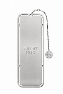 A silver metal bookmark shaped like a Bible book cover with the words 'TRUST GOD' engraved on the front, attached to a short chain with a small circular tag, shown on a plain white background.