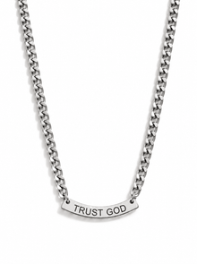 A silver-toned chain necklace with a curved bar pendant with the words 'TRUST GOD' laser cut in capital letters, shown against a plain white background.