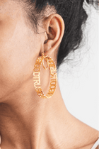Close-up of woman wearing large gold Trust God Hoop Earrings – faith-inspired Christian jewelry.